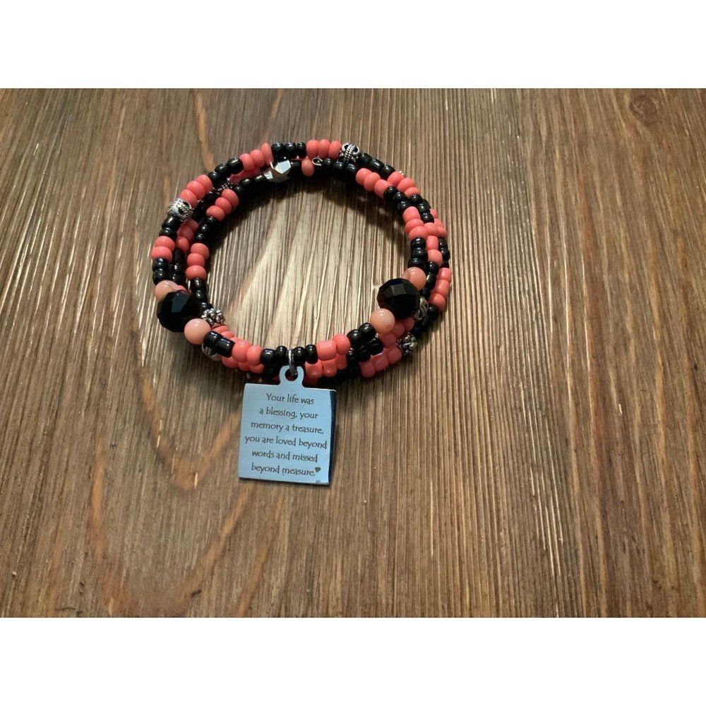 Handmade black and coral beaded wrap bracelet with laser‎ engraved charm.